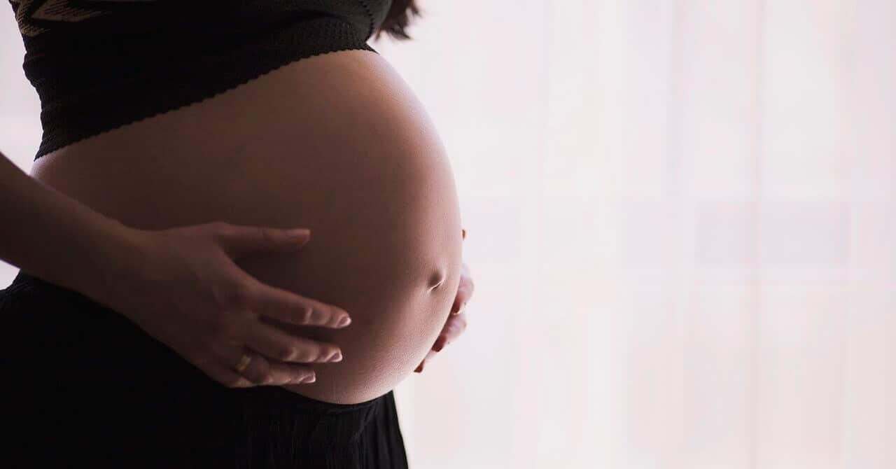 Pregnant woman touching her tummy
