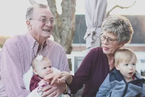 Old man and woman with their grandchildren